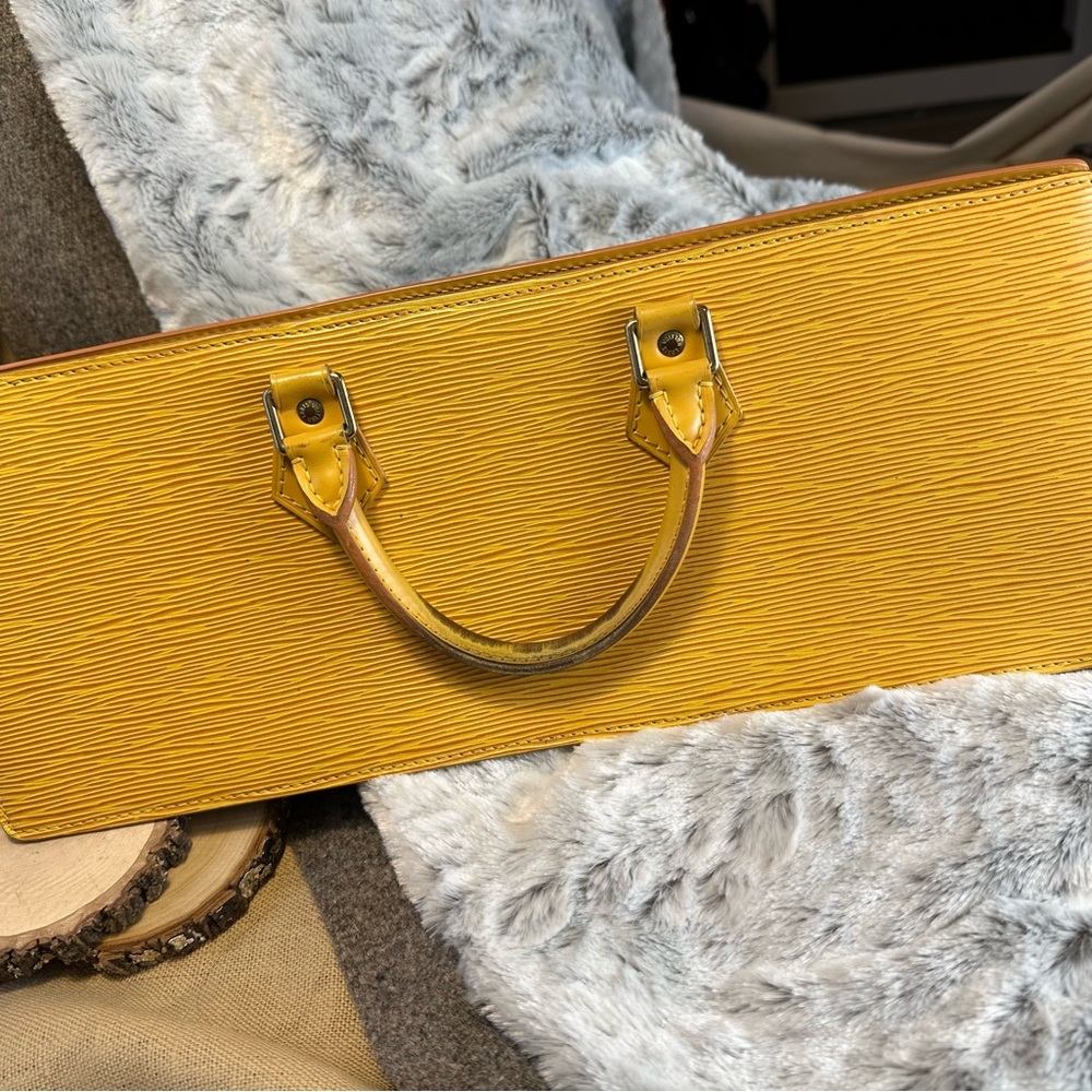 Louis Vuitton Epi Leather Triangular Handbag in Yellow Gold. $625